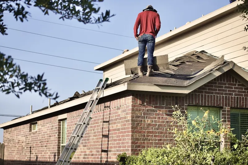 Professional roofer working on a residential roof in Durham